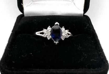 Ladies sterling silver ring with blue stone and CZs