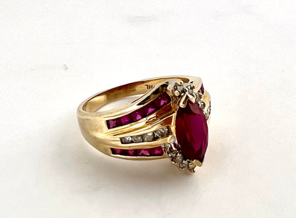 14K yellow gold ladies, Marquis shaped ruby and diamond ring